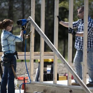 Two people using a Campbell Hausfield Air Hose outdoors