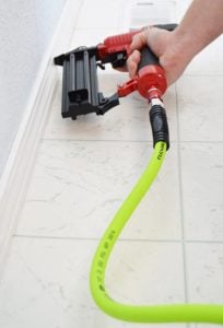 Action shot of Flexzilla hybrid air hose being used with nail gun