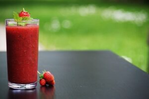 Outside with a strawberry smoothie