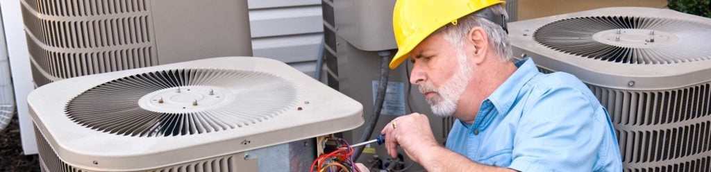 A man repairing an AC exhaust