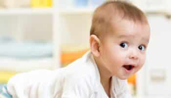 Happy Baby In Warm Nursery with Heater