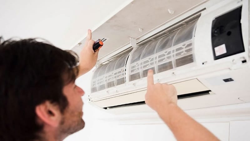 A technician checking air conditioner issues.