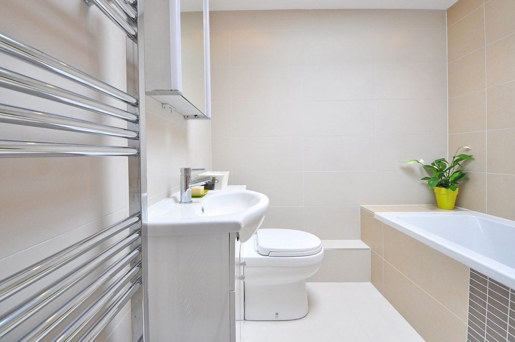 A bathroom with white, silver and beige tones