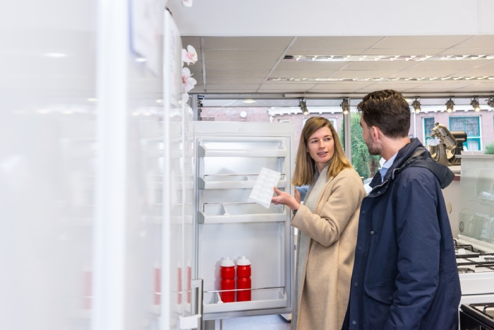 Couple deciding on a refrigerator to buy