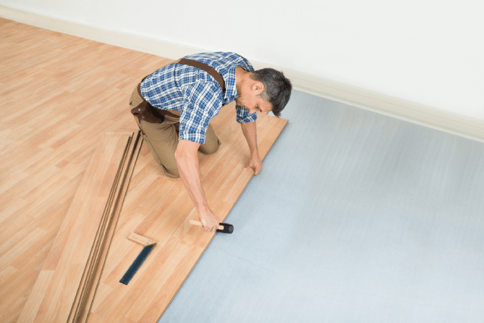 man setting up wood flooring
