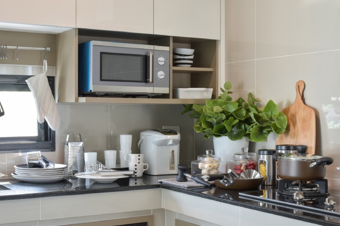 Microwave in a shelf above sink