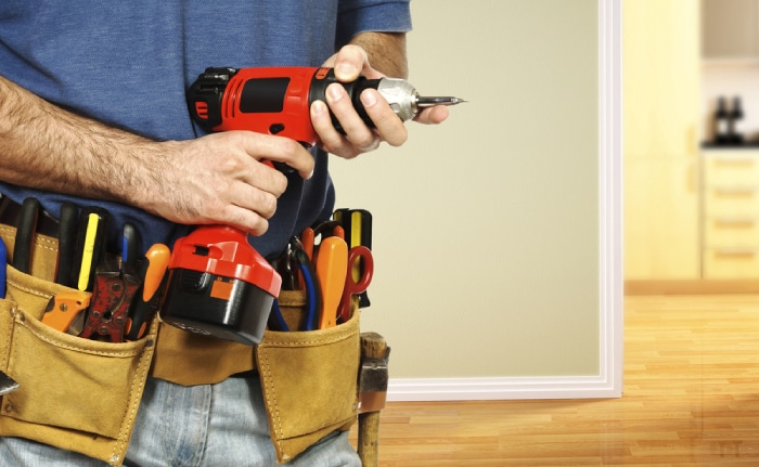 male with tool belt and hand drill