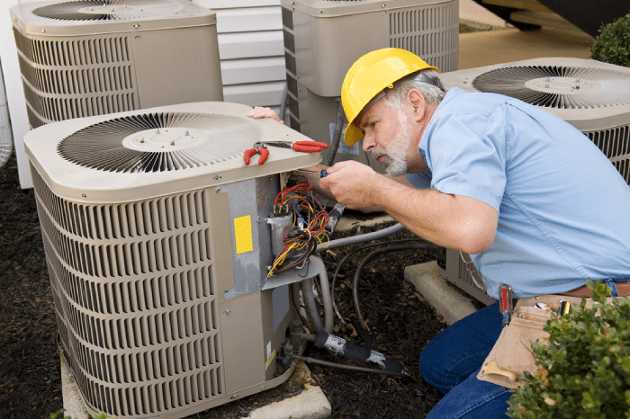 male checking HVAC unit