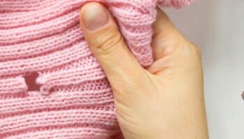 Woman hands holding a leaky sweater