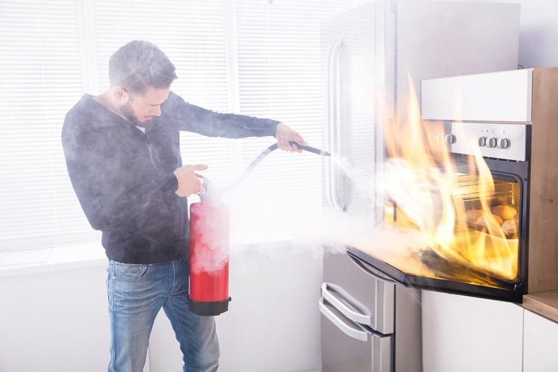 Man using a fire extinguisher