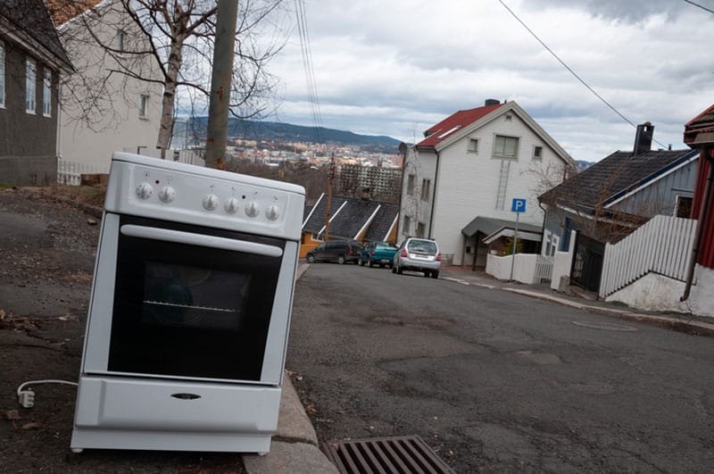 A white oven in the sidewalk