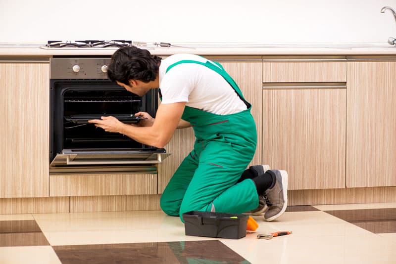 Technician fixing an oven