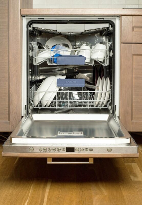 An open dishwasher full of dishes