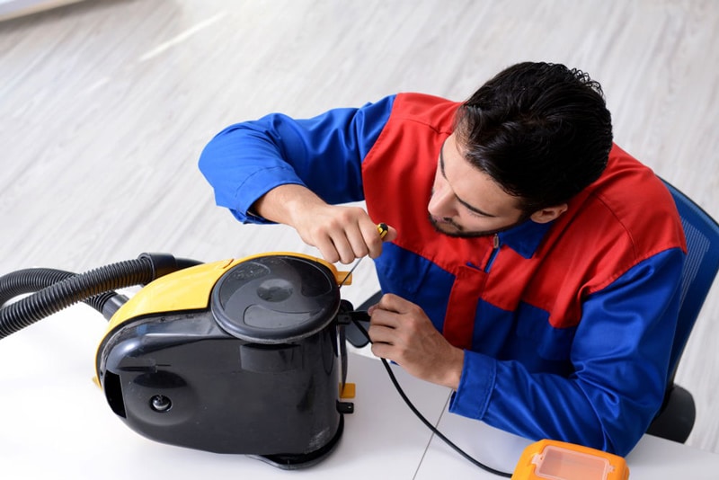 Man fixing a vacuum cleaner