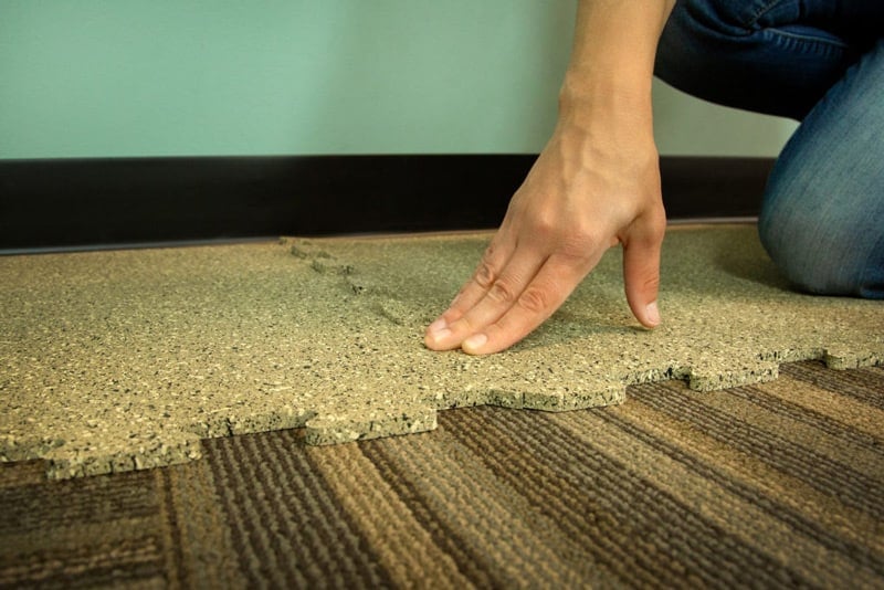 Puzzle floor mats beeing installed