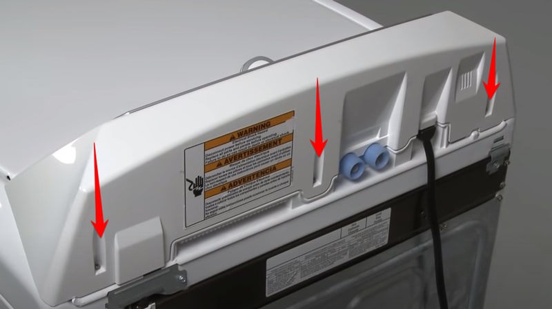 Backside of a Whirlpool dryer with red arrows pointing to screws