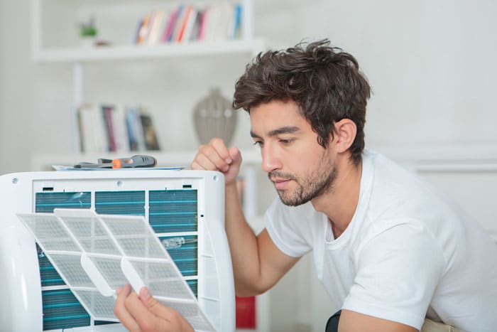 man checking air filter