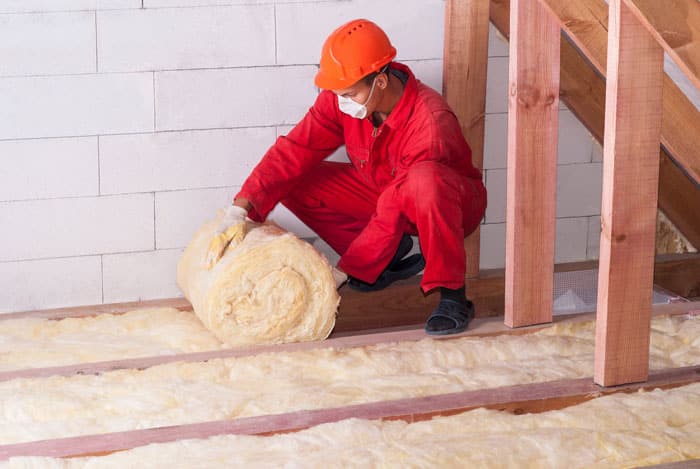 man installing insulation on the floor