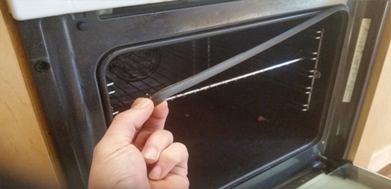 Hand removing an oven seal