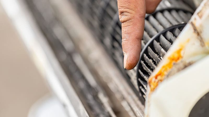 Finger pointing out air conditioner filter