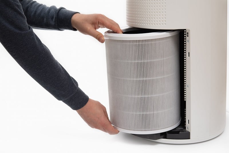 Person removing filter for air purifier