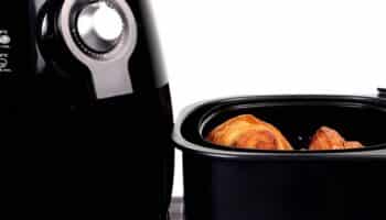 Black air fryer with cooked food