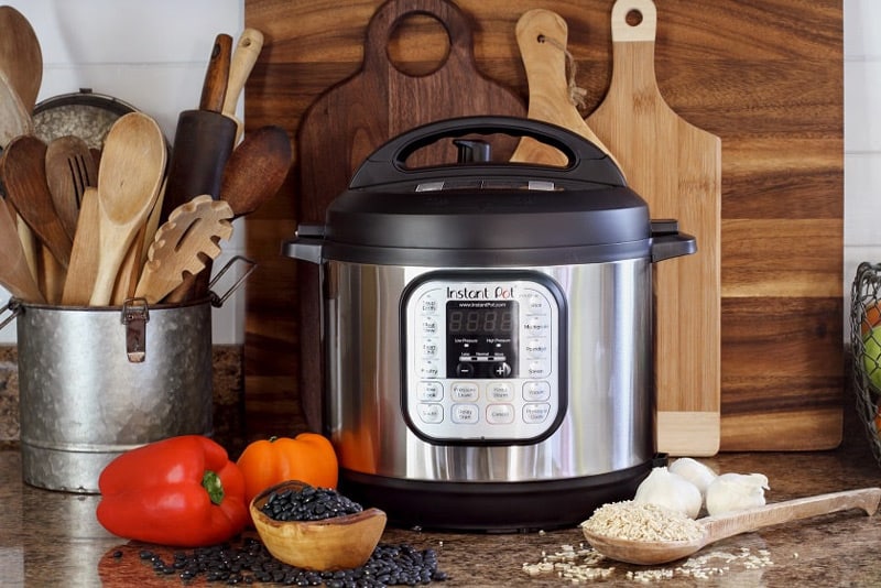 Pressure cooker with some vegetables around it