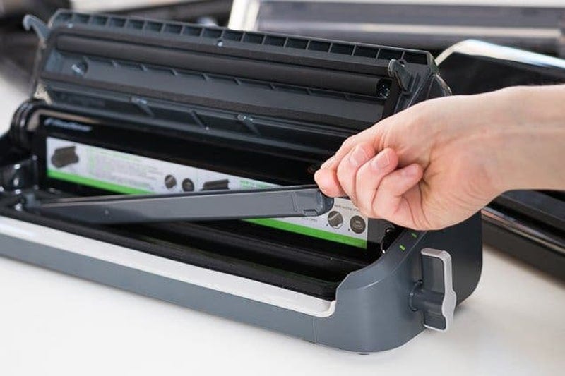 Removing drip tray from vacuum sealer