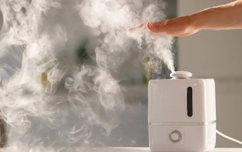 Hand Measuring How Mutch Steam Humidifier Produces