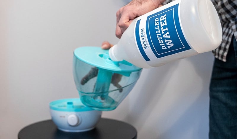 Hands Filling Humidifier With Water