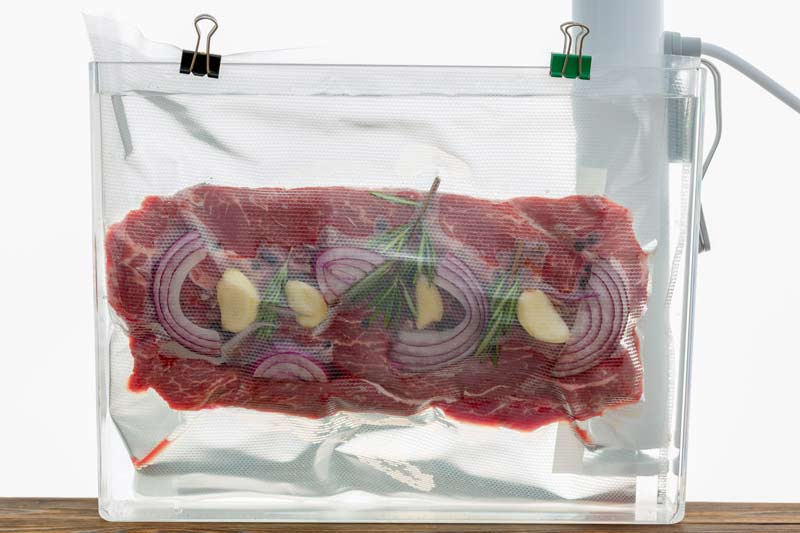 Sliced beef sous vide steak in a sealed pouch