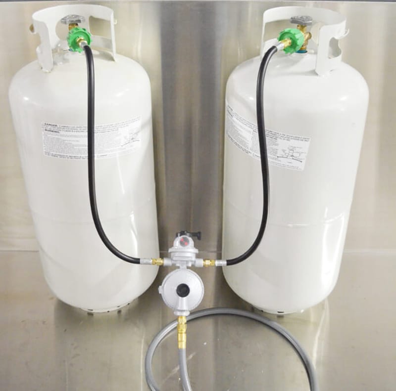 Two Propane Tanks Connected To A Regulator