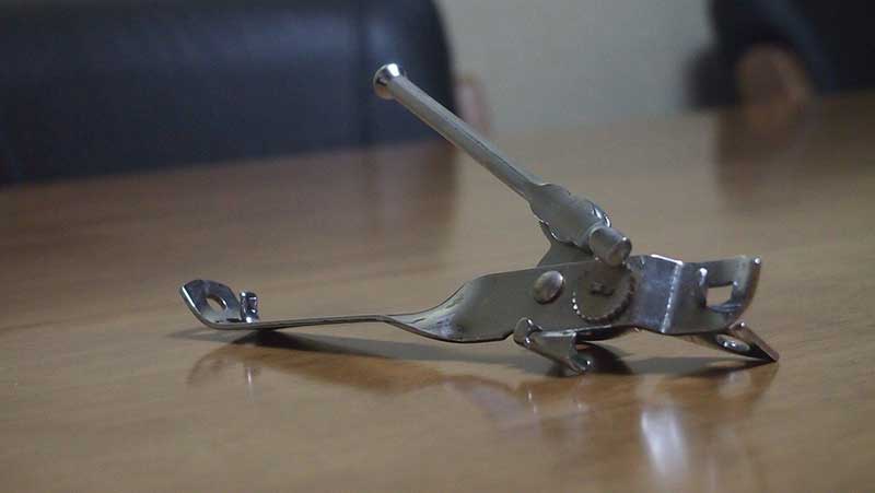 a classic can opener in the table