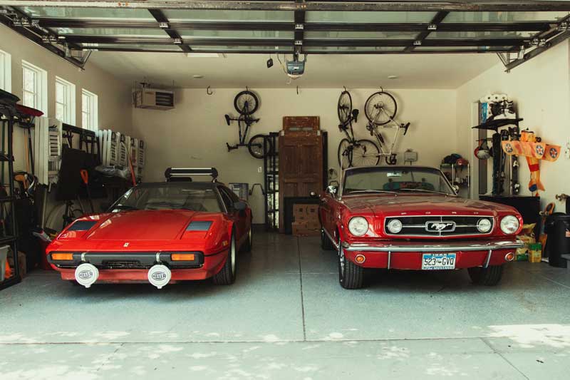 two red cars in a garage
