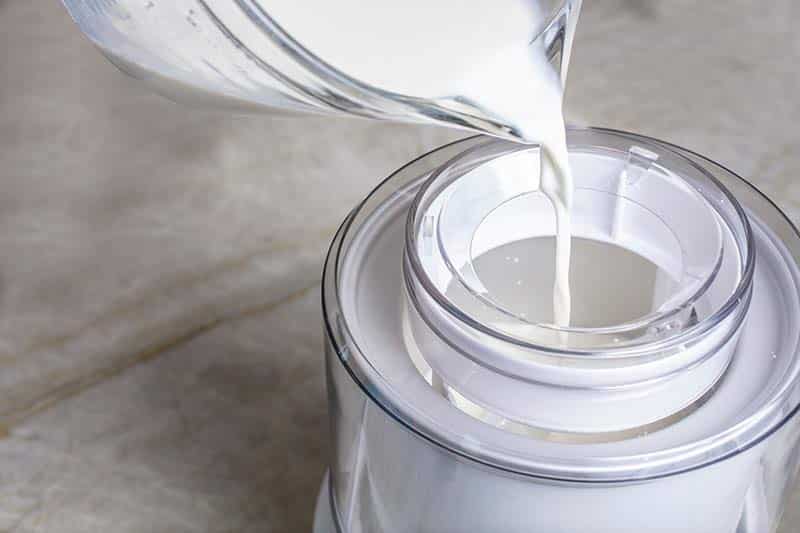 Heavy cream pouring into an ice cream maker