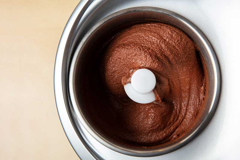chocolate ice cream in ice cream maker bowl