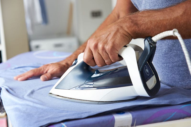 A person ironing clothes