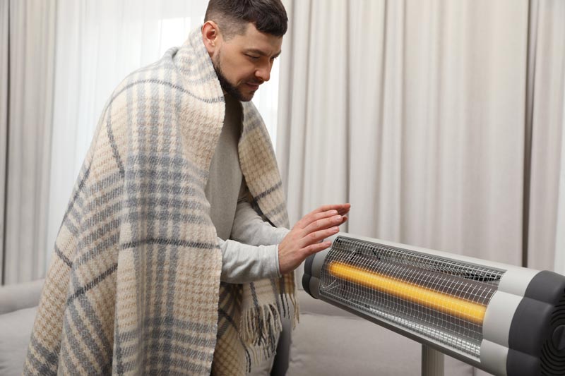 man in front of infrared heater