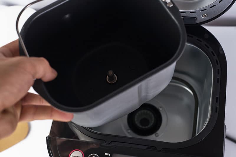 holding a bread maker pan