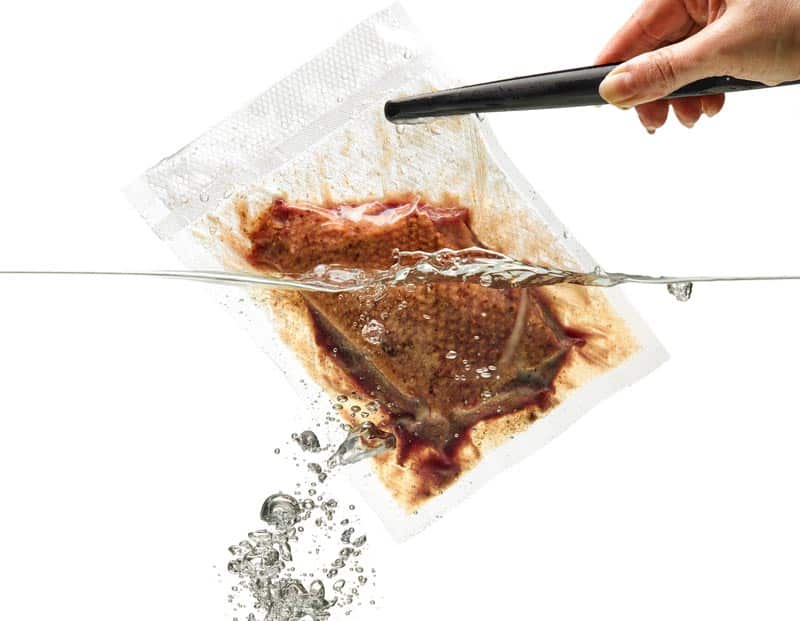 vacuum sealed bag with meat dipped in water