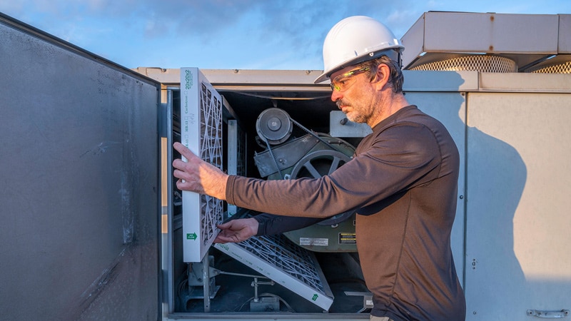 Man Inspecting Swamp Cooler Parts