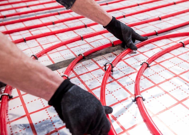 Hands Installing Heating Floor