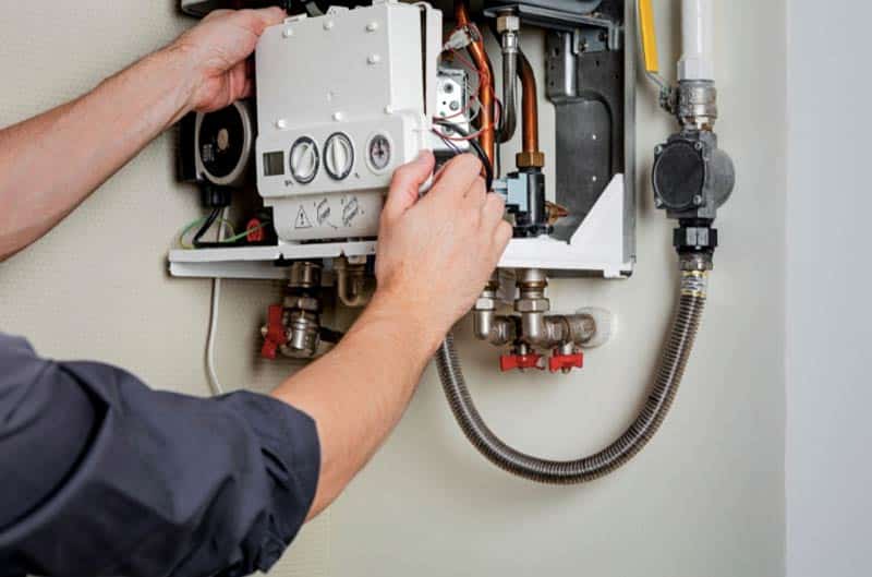 Technician Disarming Combio Boiler To Clean Diverter Valve