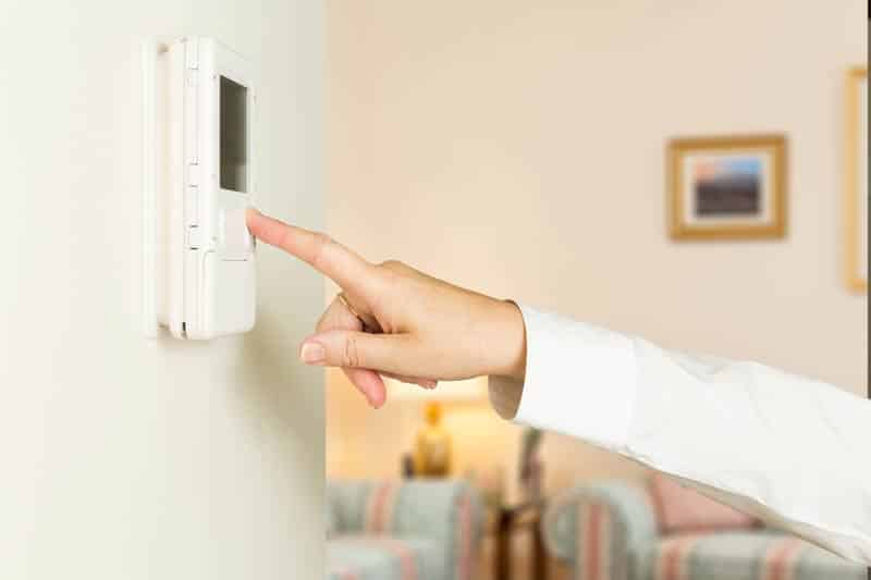 Hand Triying To Use Faulty Thermostat