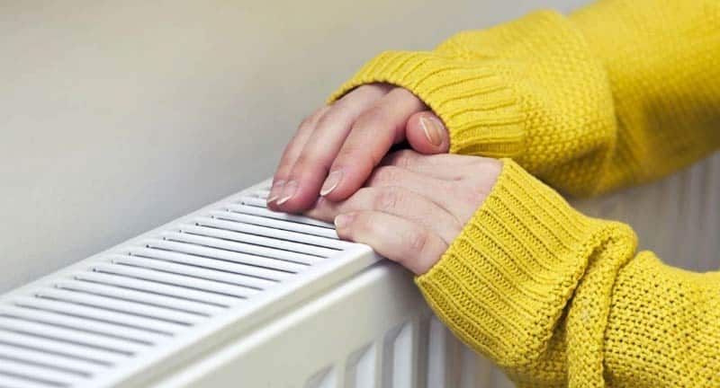 Hands Touching Cold Radiator