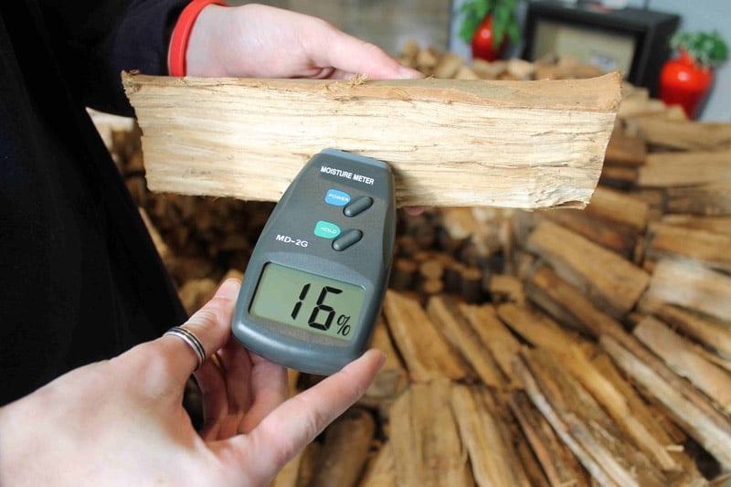 Hand Holding Moisture Meter And Measuring Moisture On Wood