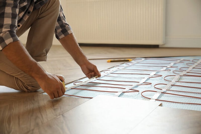 Man Removing Floor Heating System Cover