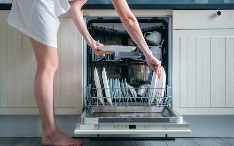Woman With No Shoes Using Dishwasher