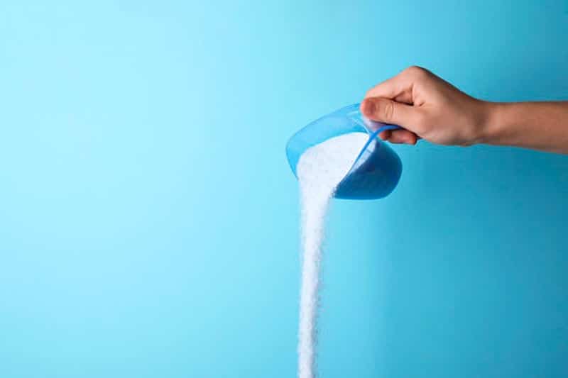 Pouring Detergent On Washer