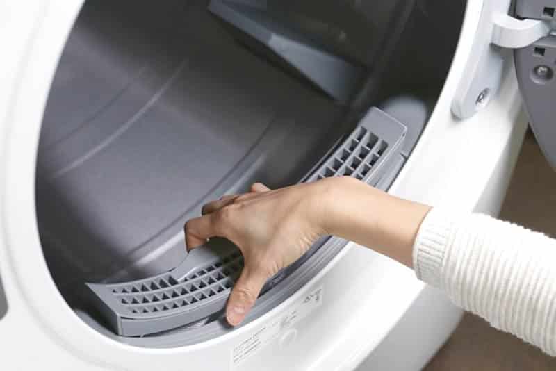 Hand Pulling Out Dryer Filter
